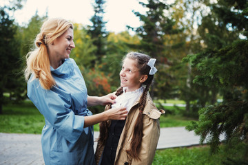 Mom with her daughter during autumn