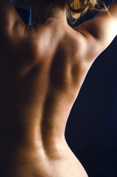 Muscule sport woman back. Sensual girl topless. Fit female figure