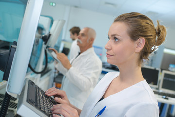 pretty scientist doing research in a lab with a computer