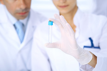 Fototapeta premium Team of scientific researchers in laboratory studying substances or blood sample. New vaccine for pharmacology industry is s almost ready. Medicine and science concept