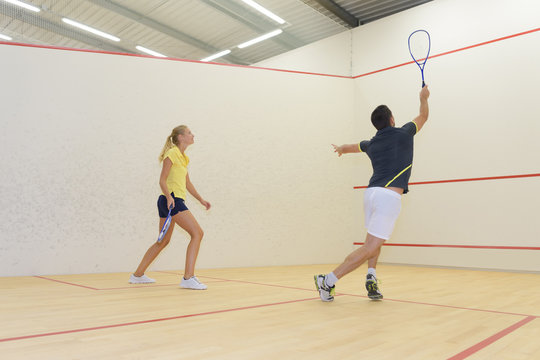 young people playing indoor tennis