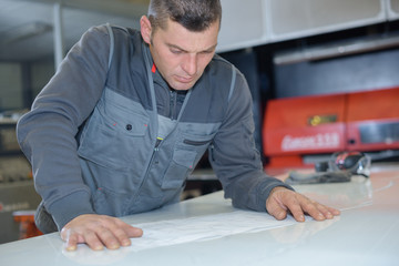 metalworker in workshop reading instructions