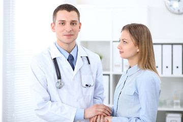 Doctor and  patient  standing straight an speaking.. Medicine and health care concept
