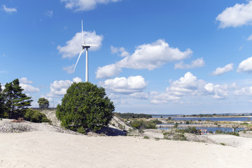 Wind turbine and a blue sky with clouds