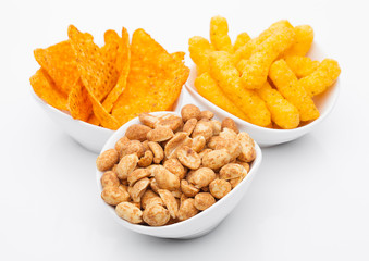 Cheese corn snacks and nachos with salty peanuts