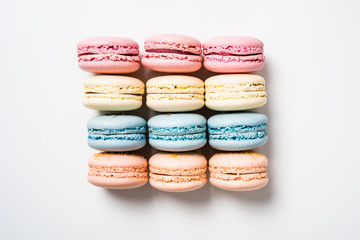 Colorful assorted macaroon cookies on white background