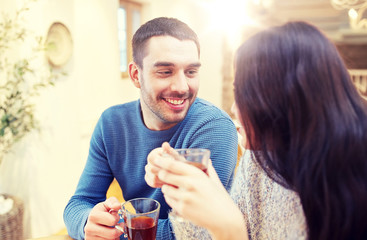 happy couple drinking tea at cafe