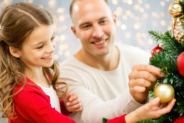 Fototapeta na wymiar father and daughter decorating christmas tree
