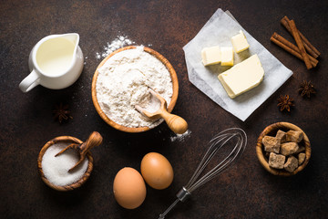 Ingredients for cooking baking. Top view on dark rusty table.