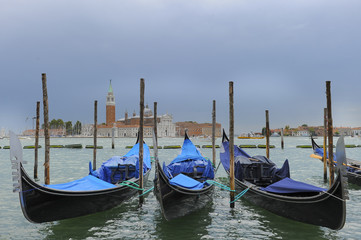 Fototapeta na wymiar Traditional gondolas in the sea on background of ancient Venice, Italy
