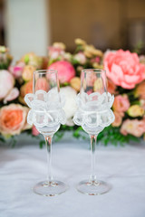table serving with glasses and flowers in hall