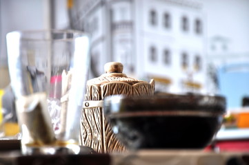 a vase with jam and a Cup on the table
