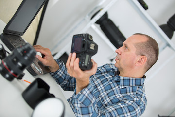technician repairing digital camera in a service laboratory