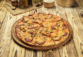 Hot pizza slice with melting cheese on a rustic wooden table.pepperoni pizza,Hot Homemade Pepperoni Pizza Ready to Eat,Supreme Pizza lifted slice