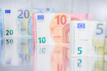 Euro banknotes  on a reflective surface