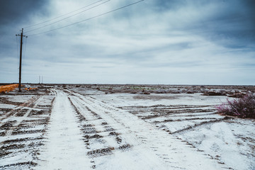 Tires traced in desert. Different tires in sand in desert under clear sky.