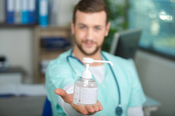 doctor showing a hand sanitizer