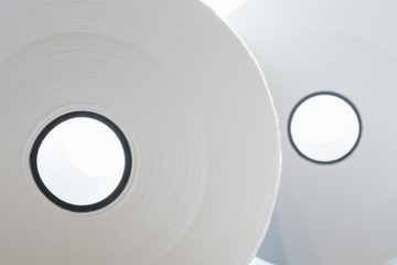 rolls of white paper with black coils on white background