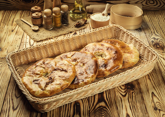 bakery product kubdari in Georgian,traditional georgian baked food kubdari on wooden table; delicious bakery cuisine of caucasus;kubdari meat