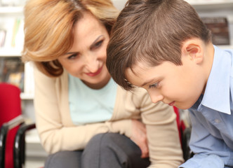 Teacher and little boy at school