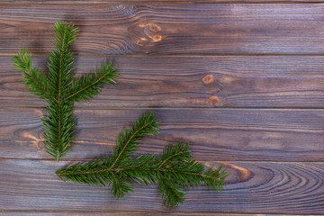 Christmas pine tree branches on old wooden board. Space for text. Top view