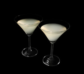 Glasses of lemon drop martini on black background