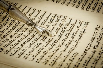 Torah pointer with a hand at the end with one finger extended to help read the text of holy...