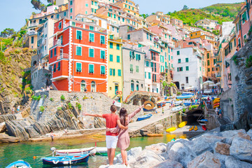 Young family with great view at old village Riomaggiore, Cinque Terre, Liguria, Italy. European...