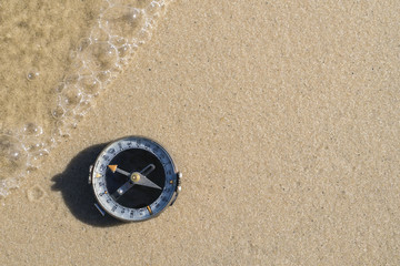 Fototapeta na wymiar Retro Compass On Sand At Beach