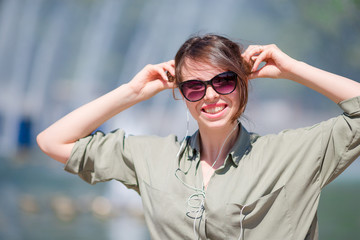 Portrait of happy young urban girl in the park outdoors