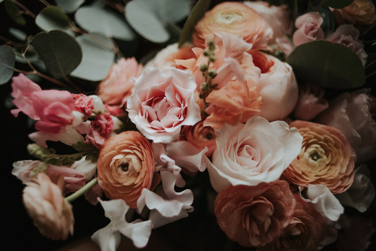 Pink and coral garden rose, ranunculus and eucalyptus bouquet - Powered by Adobe