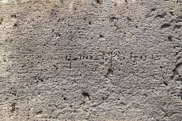 Background with texture of ancient stone wall of armenian monastery Geghard