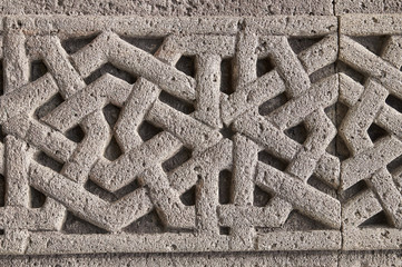 Fragment of ancient ornament on the church doorway in medieval armenian monastery Geghard close up