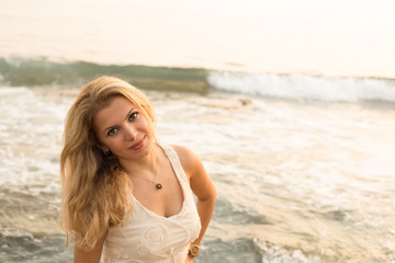 Fototapeta na wymiar Beautiful blonde woman by seaside
