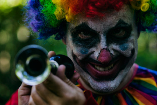 Scary Clown Holds Horn And Evil Grin