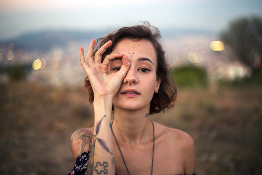 Tattooed alternative girl gesturing