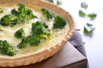 Tasty broccoli quiche on table, closeup
