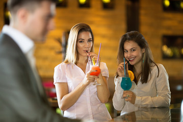 Two beautiful business women at cocktail party