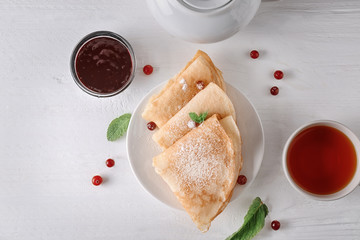 Delicious pancakes with berry jam on plate