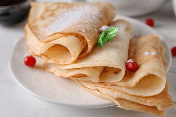 Delicious pancakes with berries on plate, closeup