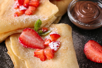 Delicious pancakes with chocolate and strawberry on plate, closeup