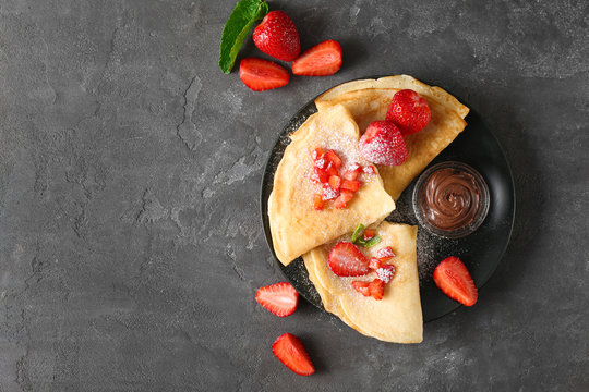 Delicious pancakes with chocolate and strawberry on table
