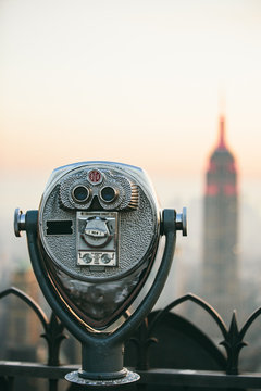 Binoculars at New York rooftop looking at Empire State building