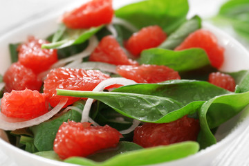 Obraz na płótnie Canvas Salad with spinach and grapefruit in plate, closeup