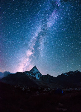 Milky way on a night sky over the mountains