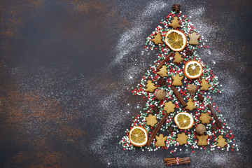 Abstract christmas tree made from festive treats and spices.Top view with copy space.
