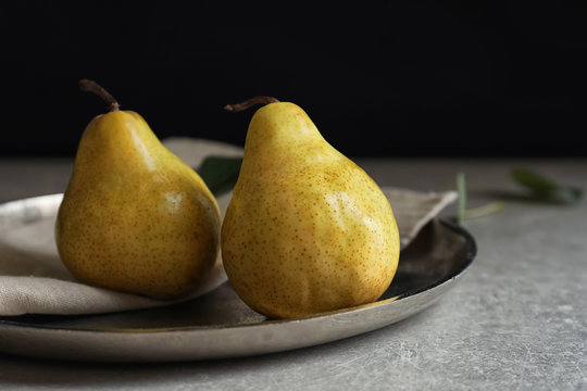 Ripe pears on metal plate