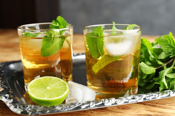 Two glasses with mint julep on metal tray