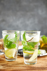 Two glasses with mint julep on wooden table