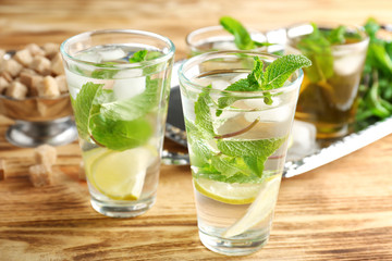 Two glasses with mint julep on wooden table